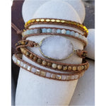  A mixture of natural stones handcrafted into genuine leather cord that is adjustable with two eyelets.