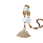 This is a fun bohemian necklace and it will get noticed! Wood beads with chunky, smooth stars that have a distressed look are completed with a tassel. Handcrafted.